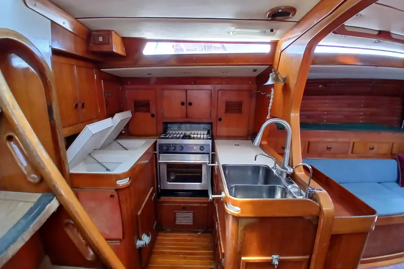 Slide: The Image of Vintage 1981 SKYE 51 yacht interior with wooden cabinetry and compact kitchen area. - 26