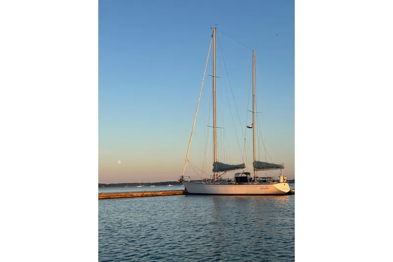 Slide: The Image of Sailboat SKYE 51 from 1981 docked at sunset with clear sky. - 3