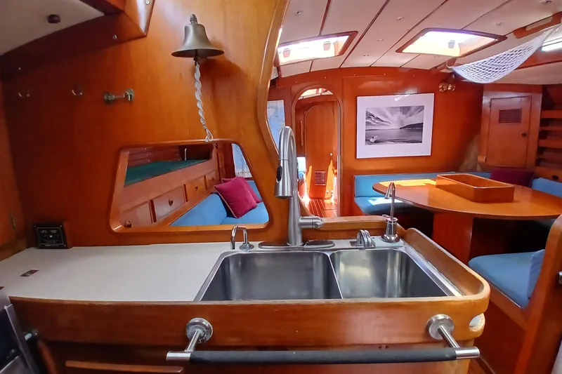 Slide: The Image of Interior of a 1981 SKYE 51 yacht with wooden finishes and a cozy dining area. - 30