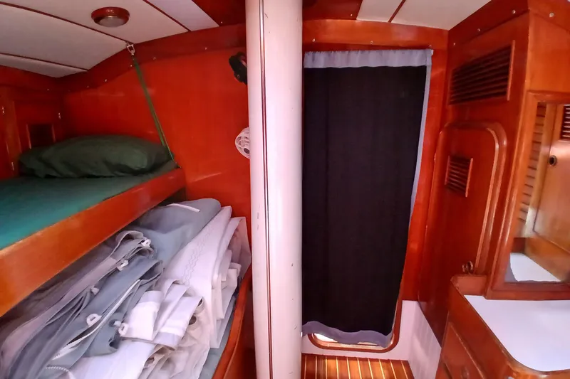 Slide: The Image of Interior of 1981 SKYE 51 sailboat cabin with wooden bunk and storage. - 38