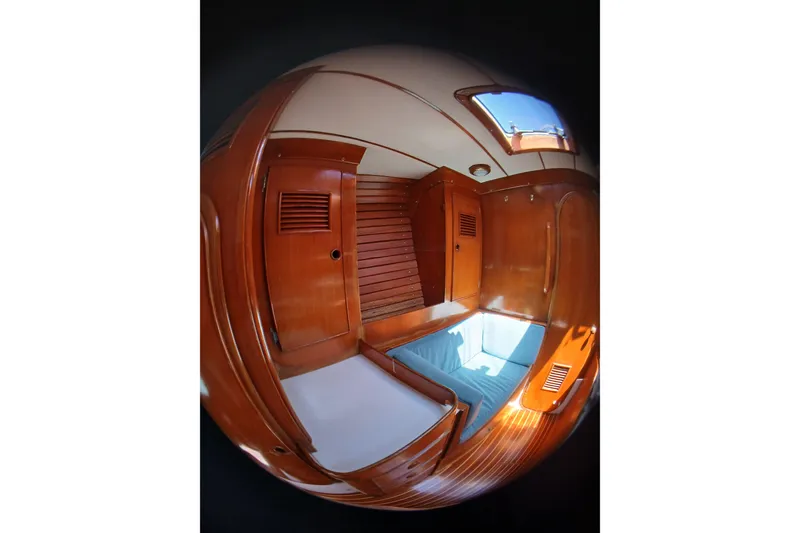 Slide: The Image of Interior of 1981 SKYE 51 yacht with wooden paneling and blue seating. - 40