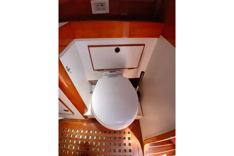 Slide: The Image of Compact marine bathroom with wooden accents on a 1981 SKYE 51 yacht. - 43