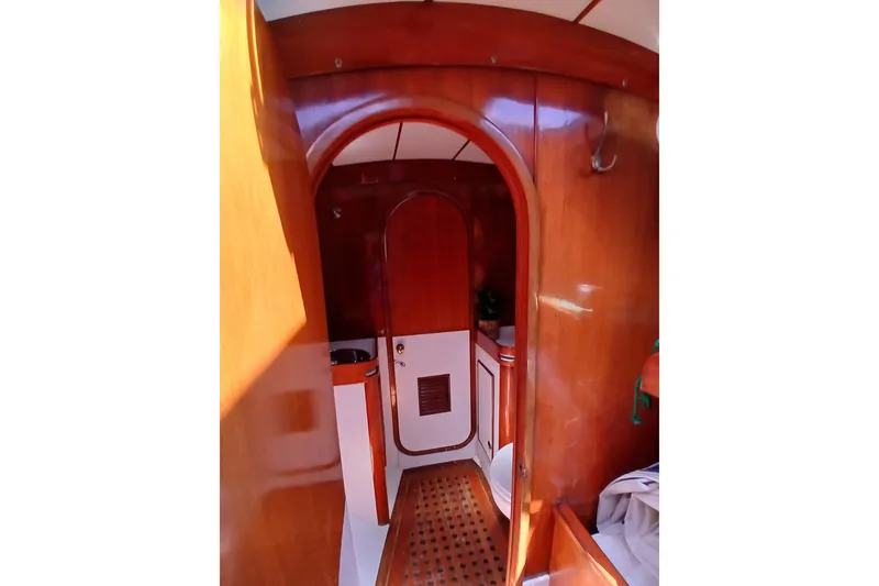 Slide: The Image of Interior of 1981 SKYE 51 yacht with wooden finishes and arched doorway. - 44