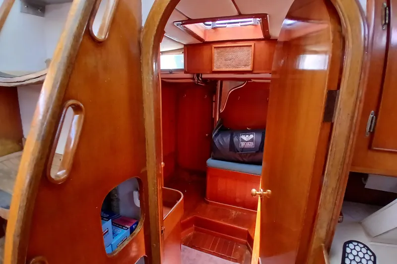 Slide: The Image of Interior of 1981 SKYE 51 sailboat with wooden finishes and cozy cabin space. - 47