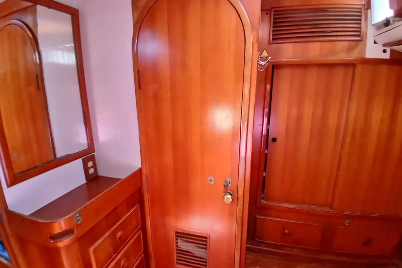 Slide: The Image of Wooden interior of 1981 SKYE 51 yacht with cabinets and mirror. - 51
