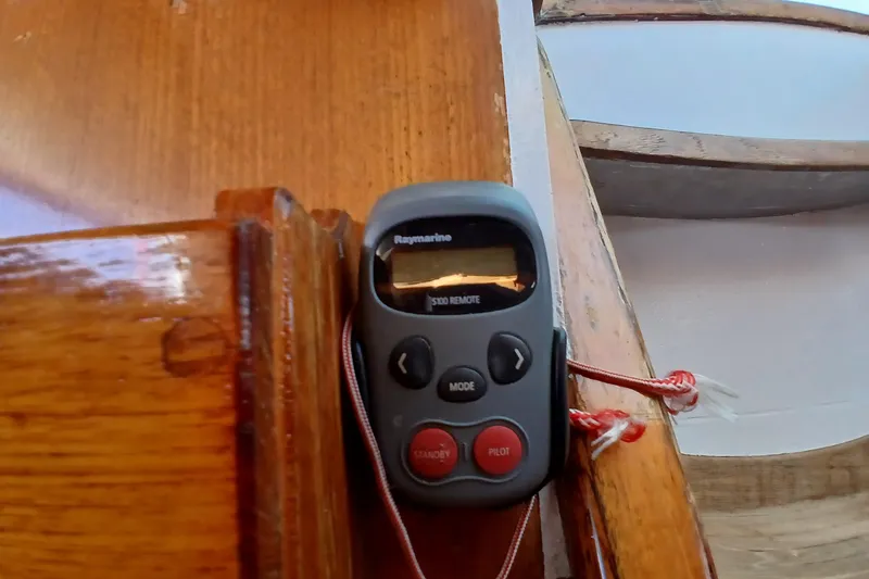 Slide: The Image of Remote control device on wooden surface, inside a 1981 SKYE 51 boat. - 55