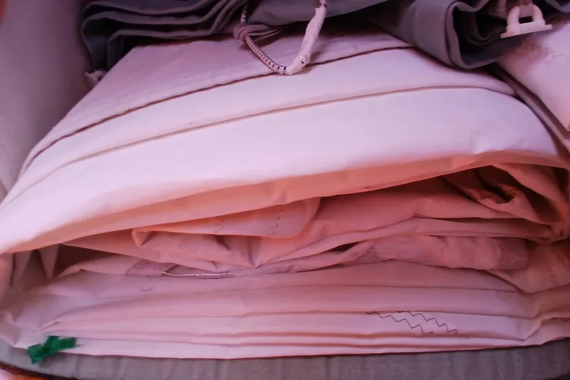 Slide: The Image of Folded sails stored neatly, possibly from a 1981 Kaufman Skye 51 yacht. - 58