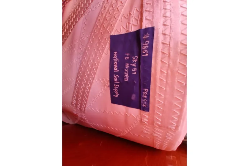 Slide: The Image of Pink sail with label from National Sail Supply for Kaufman Skye 51, 1981 model. - 61