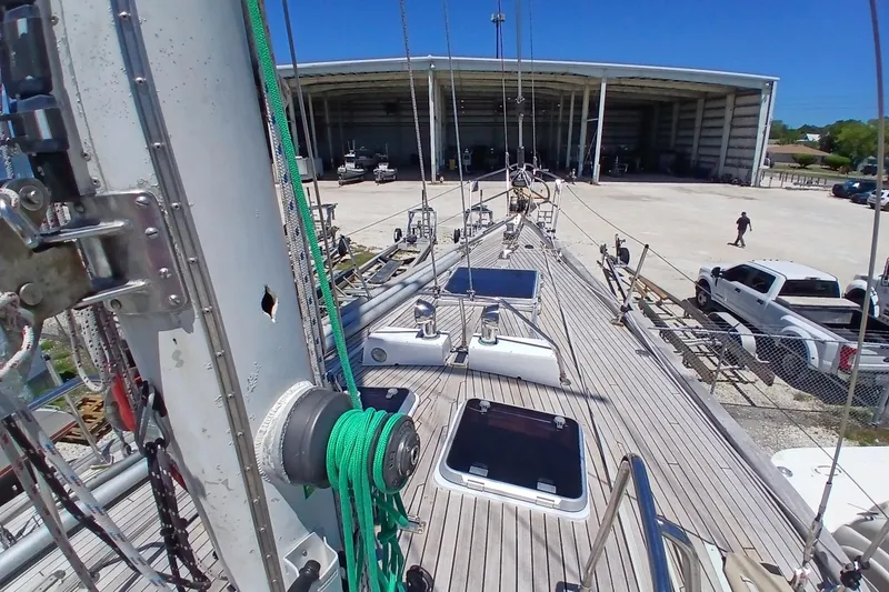 Slide: The Image of Deck view of 1981 Kaufman Skye 51 sailboat at a marina with trucks nearby. - 66