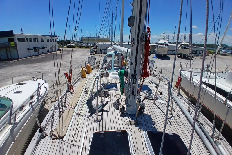 Slide: The Image of 1981 Kaufman Skye 51 sailboat on dry dock, surrounded by other boats. - 68