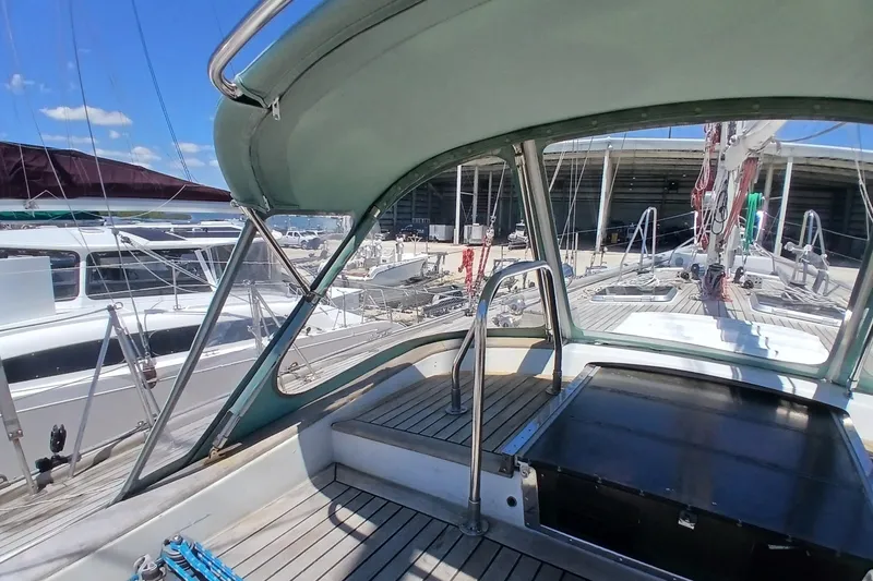 Slide: The Image of 1981 Kaufman Skye 51 sailboat cockpit with canopy, docked at marina. - 73