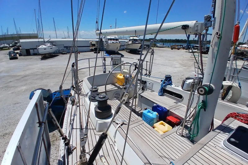 Slide: The Image of Sailboat Kaufman Skye 51, 1981 model, docked in a marina with clear blue skies. - 77