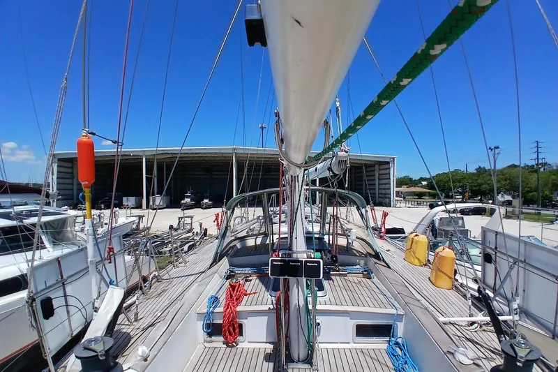 Slide: The Image of 1981 Kaufman Skye 51 sailboat docked at marina under clear blue sky. - 79