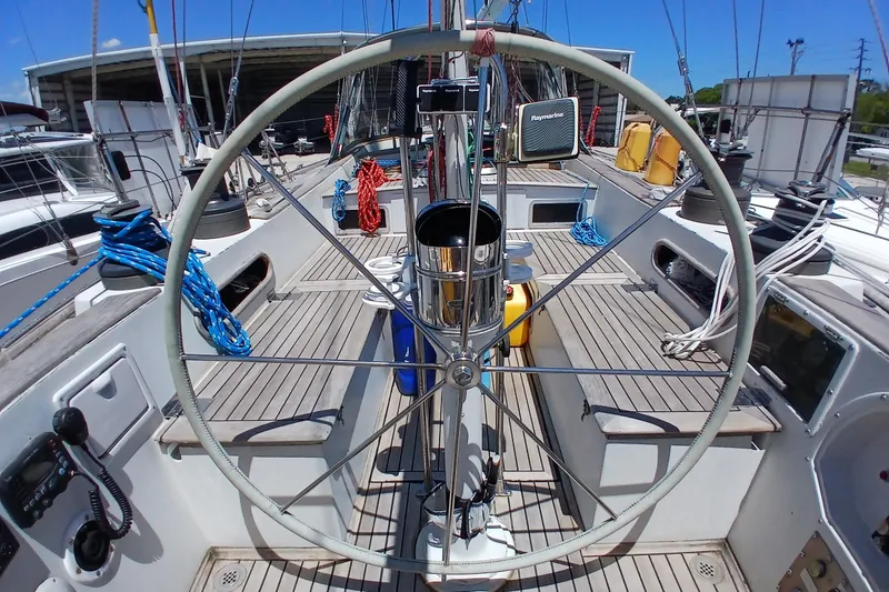 Slide: The Image of Cockpit view of 1981 Kaufman Skye 51 sailboat with steering wheel and nautical equipment. - 82