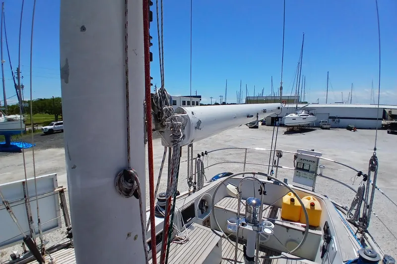 Slide: The Image of 1981 Kaufman Skye 51 sailboat mast and cockpit in a marina setting. - 85