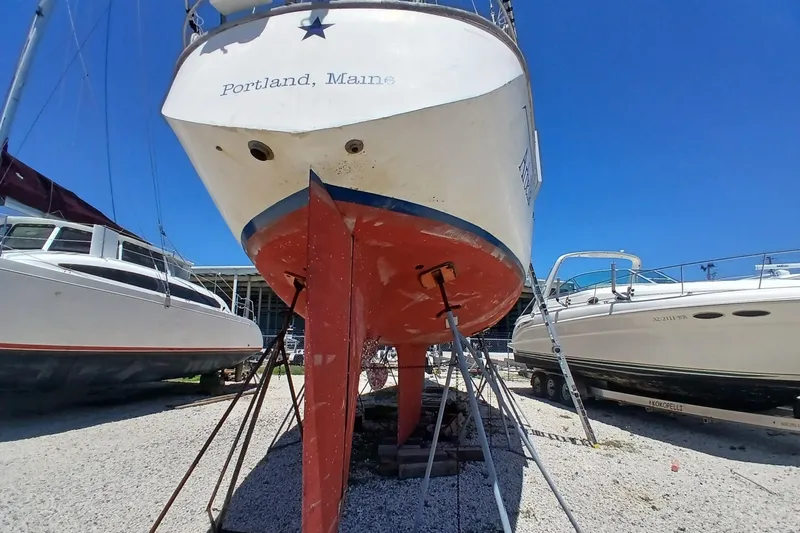Slide: The Image of Sailboat Kaufman Skye 51, 1981, docked in Portland, Maine, with clear blue sky. - 90