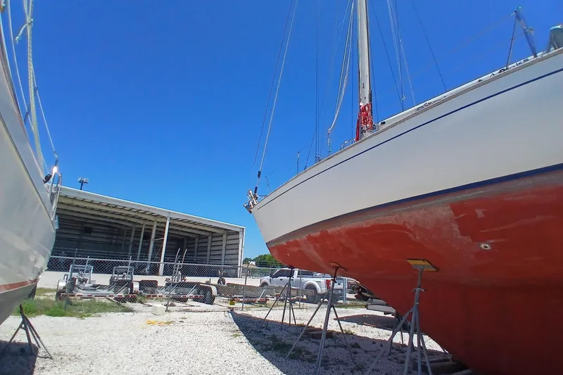 Slide: The Image of 1981 Kaufman Skye 51 sailboat on stands, blue sky background. - 92
