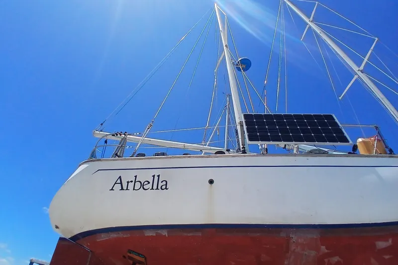 Slide: The Image of Sailboat "Arbella" with solar panel, Kaufman Skye 51, 1981, under clear blue sky. - 95