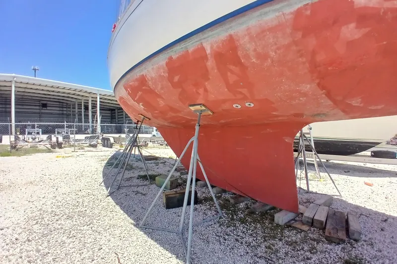 Slide: The Image of 1981 Kaufman Skye 51 sailboat on stands, hull maintenance in progress. - 96