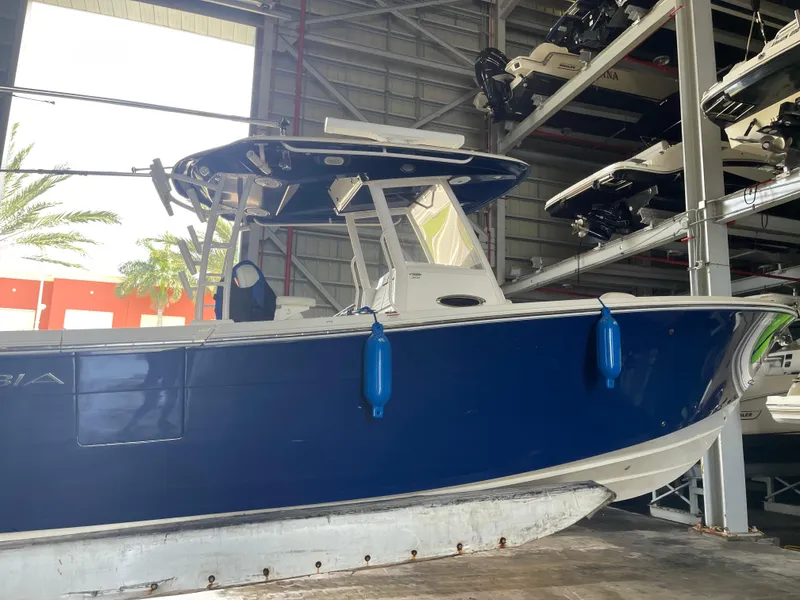 Slide: The Image of 2018 Cobia 301 Center Console boat in storage facility. - 2