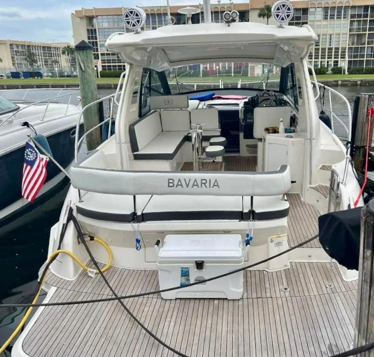 Slide: The Image of 2016 Bavaria Sport 360 HT yacht docked, featuring spacious seating and modern amenities. - 11