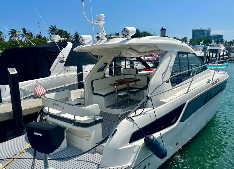 Slide: The Image of 2016 Bavaria Sport 360 HT yacht docked at marina on a sunny day. - 2