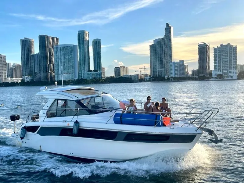 Slide: The Image of Bavaria Sport 360 HT 2016 yacht cruising near city skyline at sunset. - 4