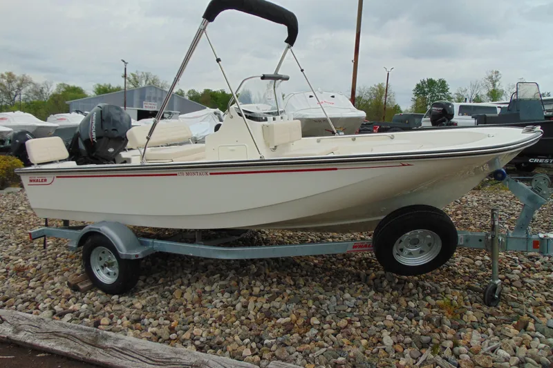 The Image of 2026 Boston Whaler 170 Montauk boat on trailer, parked outdoors. - 1