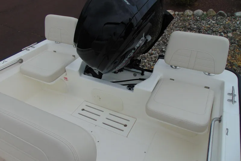 Slide: The Image of 2026 Boston Whaler 170 Montauk boat interior with seating and outboard motor. - 12
