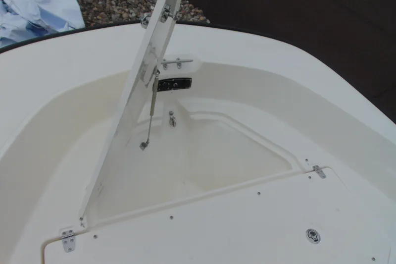Slide: The Image of Open storage compartment on 2026 Boston Whaler 170 Montauk boat deck. - 13