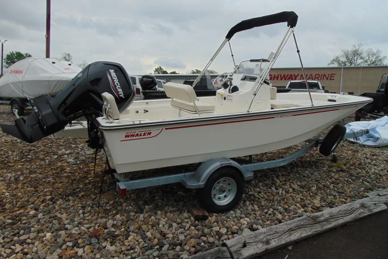 Slide: The Image of 2026 Boston Whaler 170 Montauk boat on trailer, featuring Mercury outboard motor. - 3