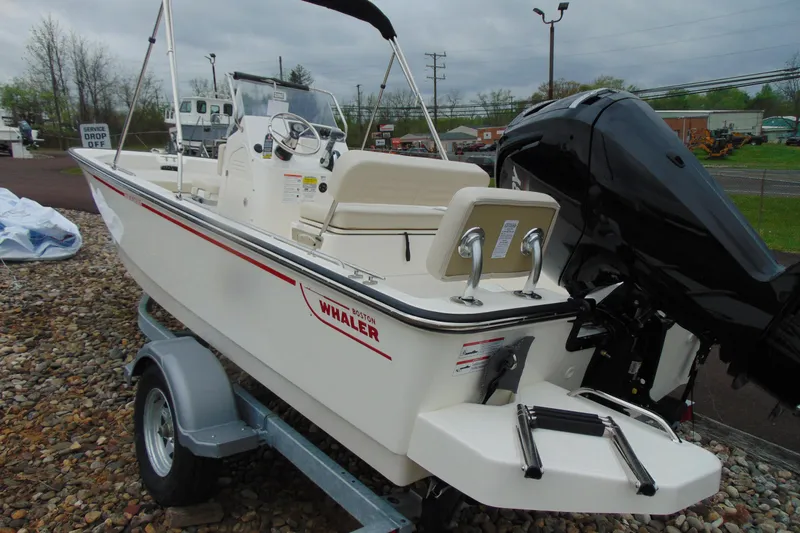 Slide: The Image of 2026 Boston Whaler 170 Montauk boat on trailer, featuring sleek design and powerful outboard motor. - 4