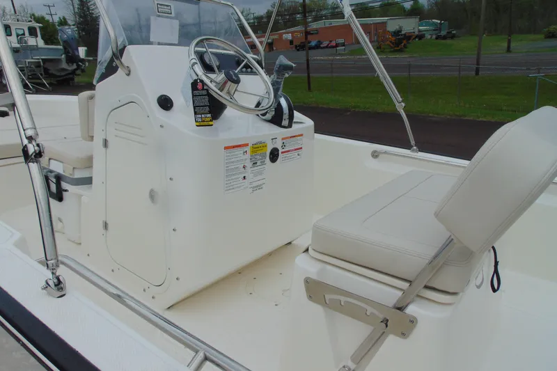Slide: The Image of 2026 Boston Whaler 170 Montauk boat interior with steering console and seating. - 6