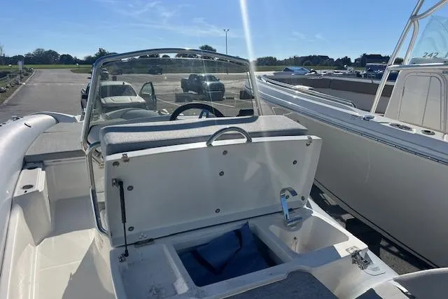 Slide: The Image of 2023 Zodiac N-ZO 680 boat with open storage compartment, parked outdoors. - 18