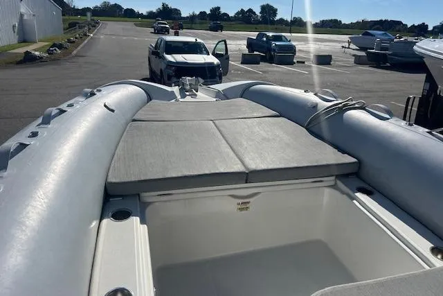 Slide: The Image of 2023 Zodiac N-ZO 680 inflatable boat with cushioned seating, parked in a marina. - 19