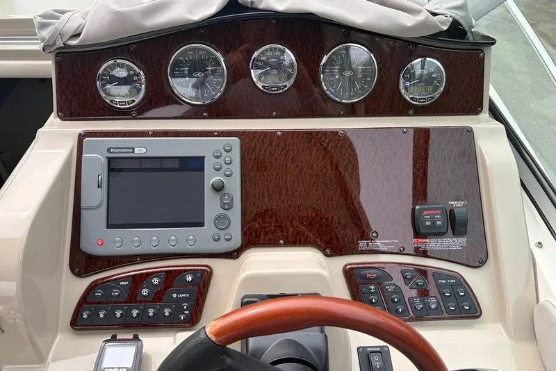 Slide: The Image of Dashboard of a 2008 Sea Ray Sundancer 310 with gauges and navigation controls. - 10