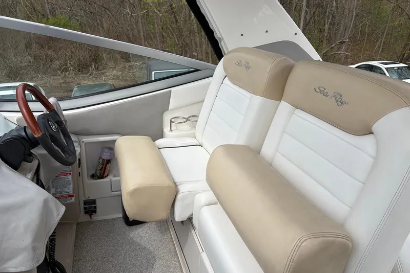 Slide: The Image of 2008 Sea Ray Sundancer 310 cockpit with beige and white seating, wooden steering wheel. - 12