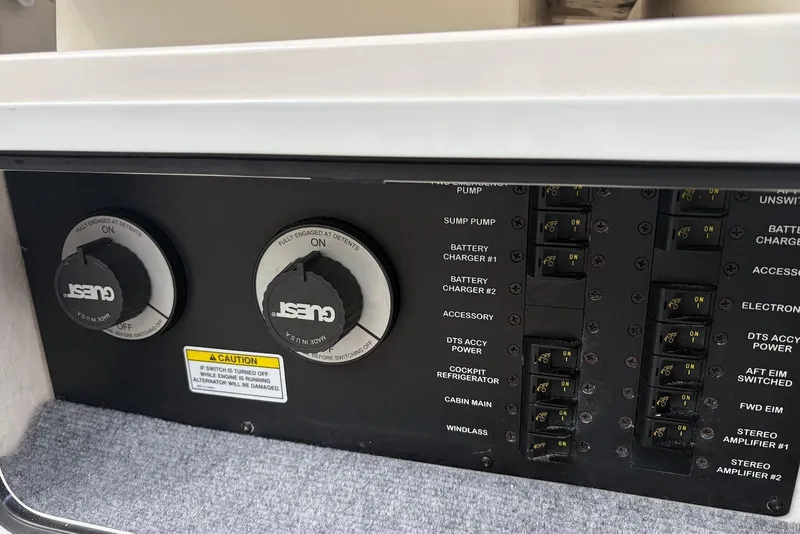 Slide: The Image of Control panel of a 2008 Sea Ray Sundancer 310 boat, featuring switches and dials. - 15