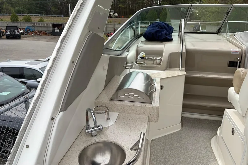 Slide: The Image of 2008 Sea Ray Sundancer 310 boat interior with kitchenette and seating area. - 16