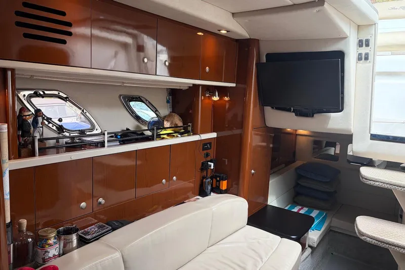 Slide: The Image of Interior of 2008 Sea Ray Sundancer 310 yacht with modern amenities and cozy seating. - 18