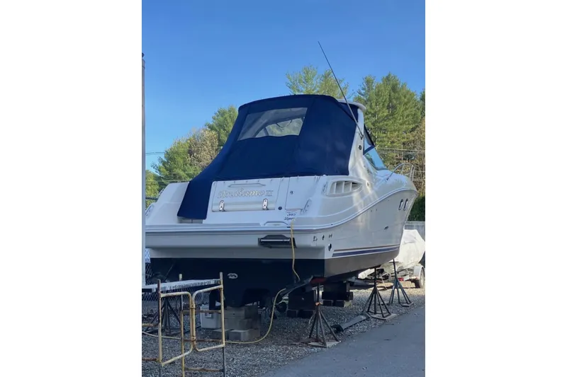 Slide: The Image of 2008 Sea Ray Sundancer 310 boat on stands, covered, outdoors. - 2