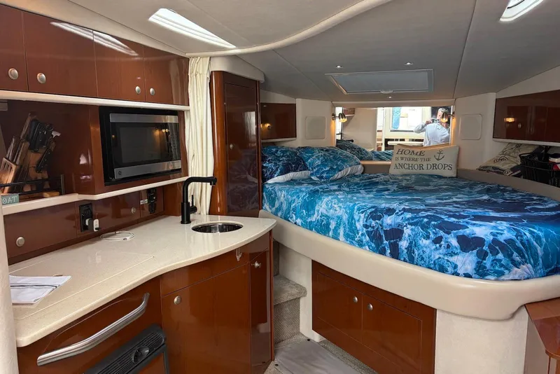 Slide: The Image of Interior of 2008 Sea Ray Sundancer 310 with kitchenette and cozy sleeping area. - 20