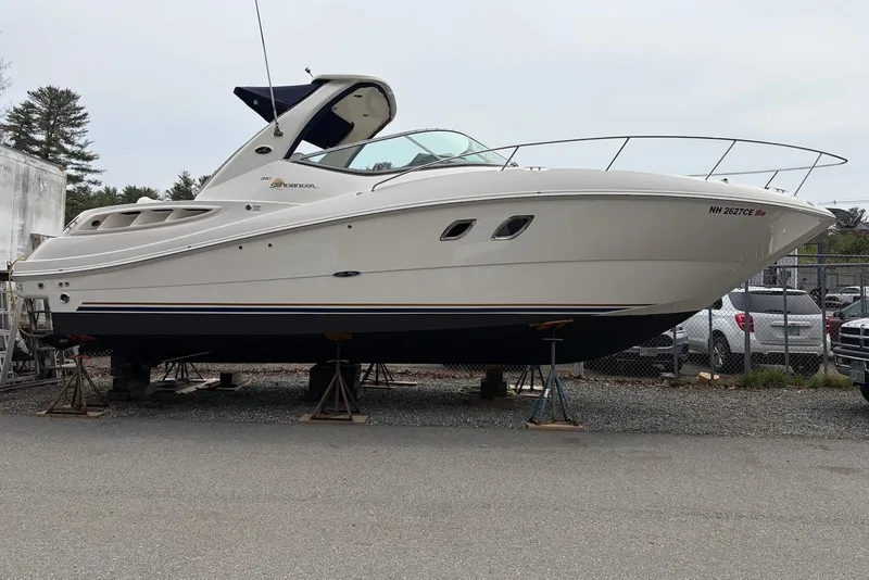 Slide: The Image of 2008 Sea Ray Sundancer 310 boat on stands, side view, in a storage yard. - 3