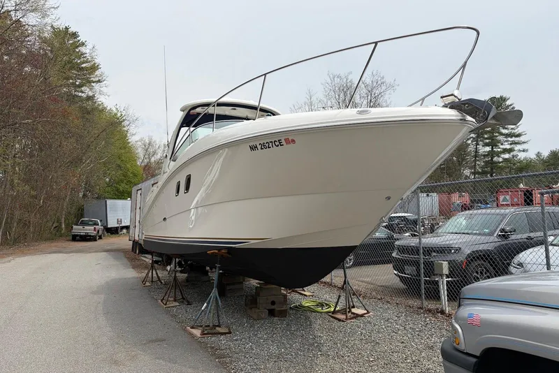 Slide: The Image of 2008 Sea Ray Sundancer 310 boat on stands in a storage yard. - 30