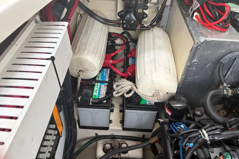 Slide: The Image of Engine compartment of a 2008 Sea Ray Sundancer 310 with batteries and wiring. - 37