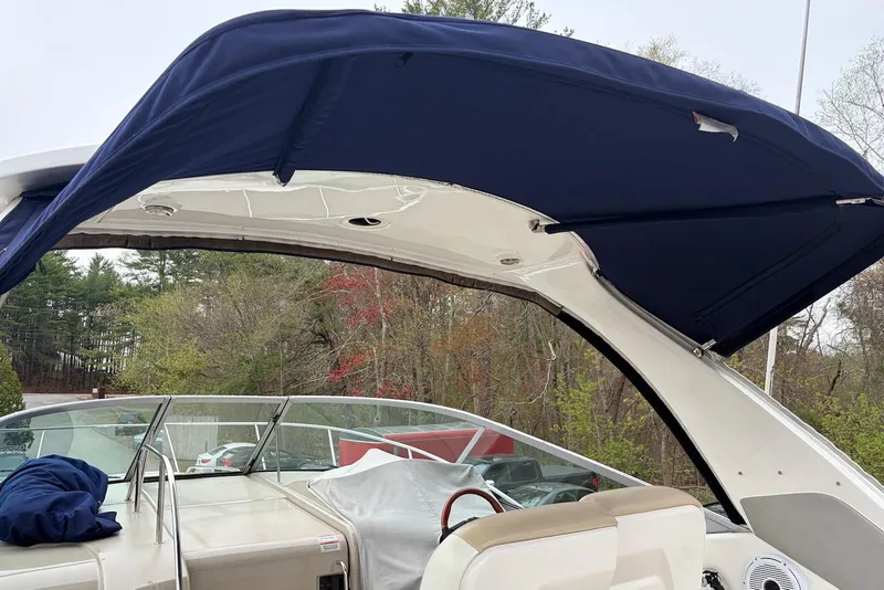 Slide: The Image of 2008 Sea Ray Sundancer 310 with blue canopy, showcasing cockpit and seating area. - 4