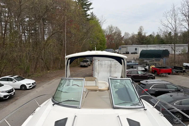 Slide: The Image of 2008 Sea Ray Sundancer 310 boat parked near cars and trees. - 6