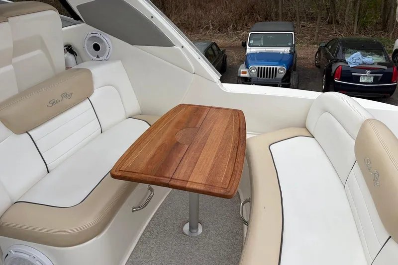 Slide: The Image of 2008 Sea Ray Sundancer 310 interior with wooden table and cushioned seating. - 9