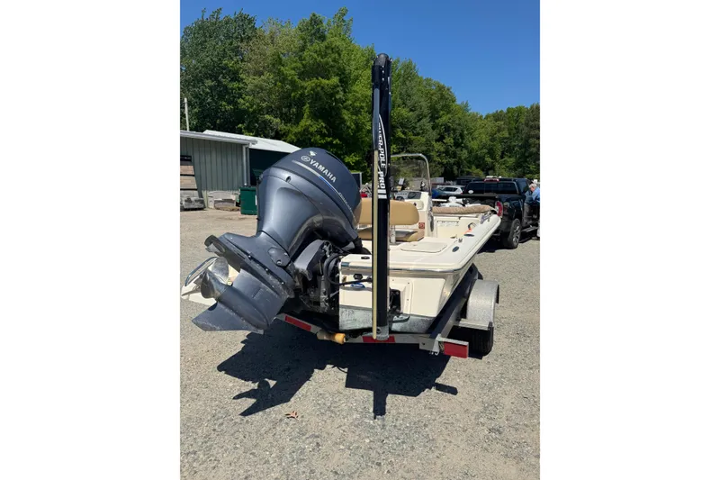 Slide: The Image of 2015 Scout 177 Sport boat with Yamaha outboard motor on trailer, parked outdoors. - 12