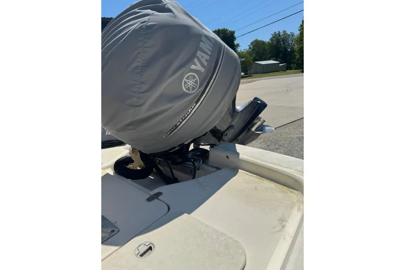 Slide: The Image of 2015 Scout 177 Sport boat with Yamaha outboard motor, covered and parked outdoors. - 15
